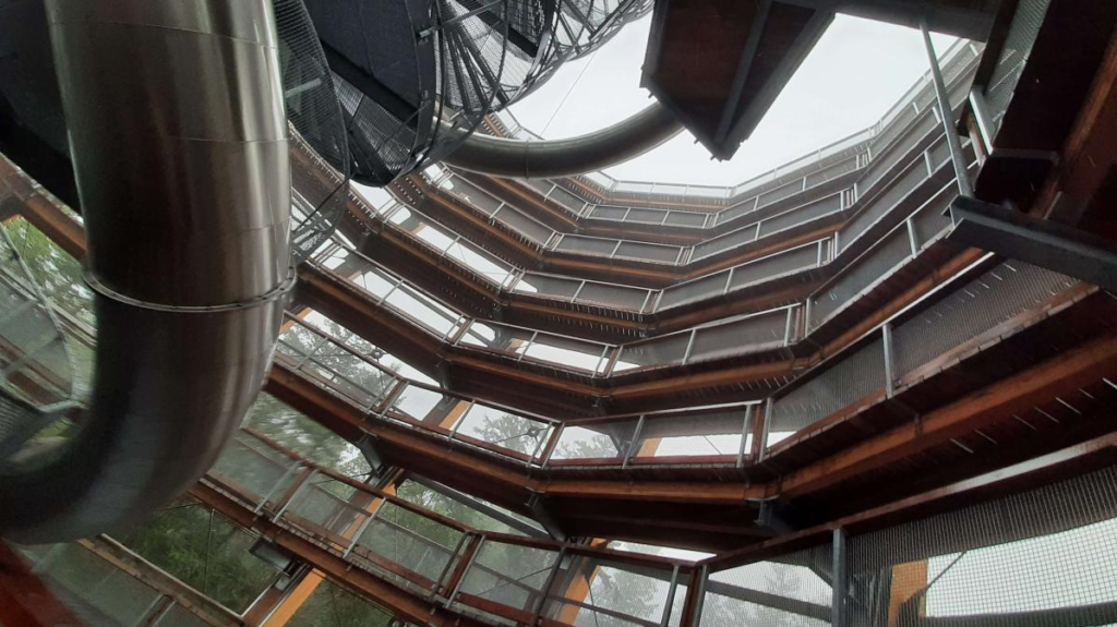 Photo of the circling tower with platforms, photo taken from an angle upwards, 7 levels, foggy background